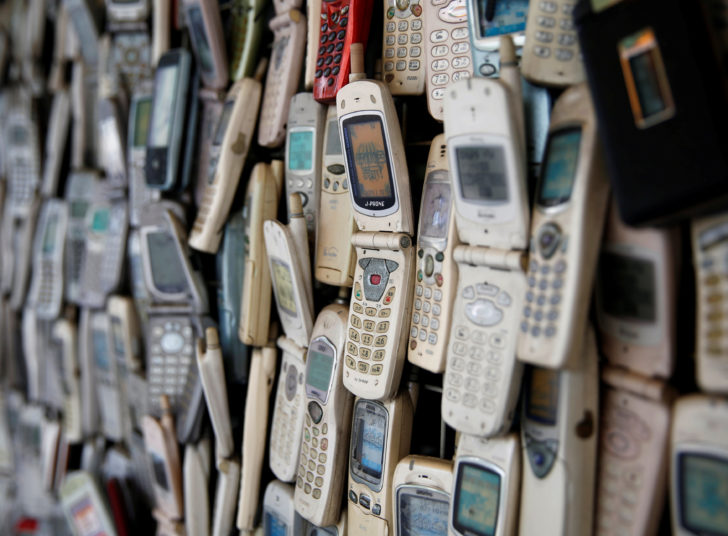 An electronic shop's wall decorated with old cell phones which its owner Watanabe Masanao had collected over 20 years is pictured in Tokyo