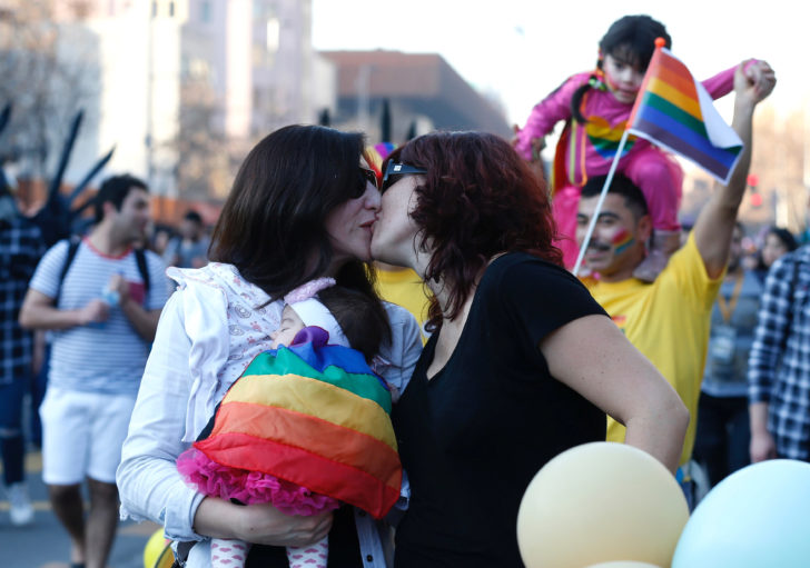 FILE PHOTO: A couple kisses during the gay pride to demand a new law of gender equality after President Michelle Bachelet sets marriage equality as government priority, Santiago