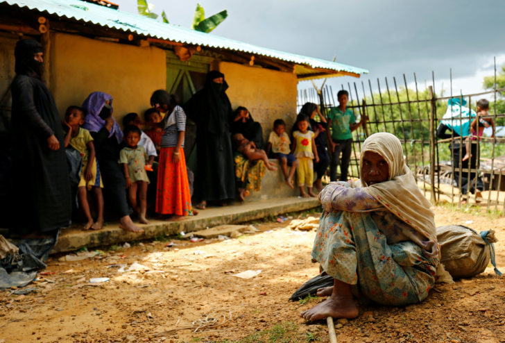 New Rohingya refugees sit near the Kutupalang makeshift refugee camp, in Cox's Bazar