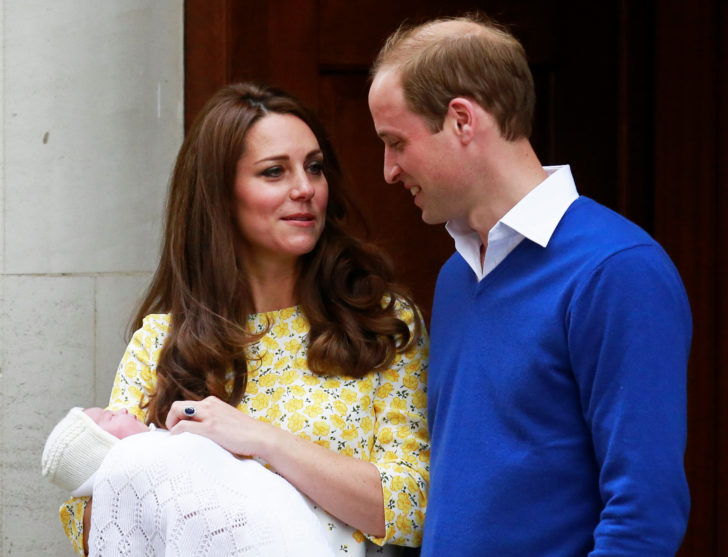 FILE PHOTO: Britain's Prince William and his wife Catherine, Duchess of Cambridge stand with their baby daughter outside the Lindo Wing of St Mary's Hospital in London