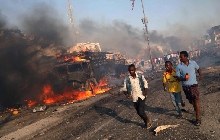 Civilians evacuate from the scene of explosion in Mogadishu