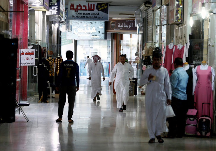 People shop at a market in Riyadh