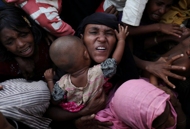 Rohingya refugees scuffle as they wait to receive relief aid at Kutupalong refugee camp, near Cox's Bazar