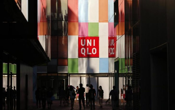 People stand outside a UNIQLO shop in Beijing