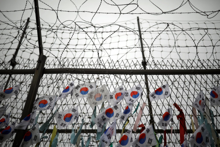 South Korean national flags hang on a barbed-wire fence near the demilitarized zone separating the two Koreas in Paju