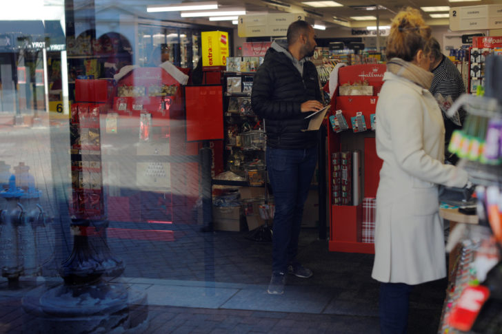 Customers wait in line and shop at CVS store and pharmacy in Cambridge