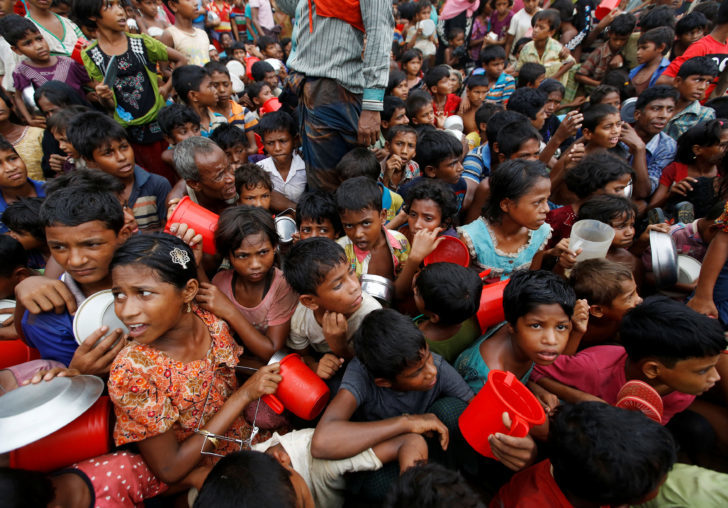 Rohingya refugee children wait to receive food outside the distribution center at Palong Khali refugee camp near Cox's Bazar