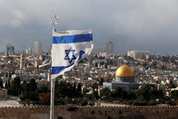 FILE PHOTO: An Israeli flag is seen near the Dome of the Rock, located in Jerusalem's Old City on the compound known to Muslims as Noble Sanctuary and to Jews as Temple Mount