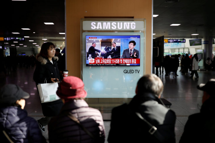 People watch a TV broadcasting a news report on a high-level talks between the two Koreas at the truce village of Panmunjom, in Seoul