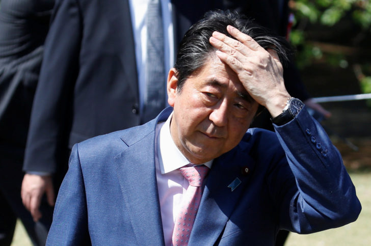 Japan's Prime Minister Shinzo Abe speaks to reporters after he attends a cherry blossom viewing party at Shinjuku Gyoen park in Tokyo