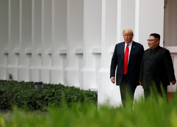 U.S. President Donald Trump and North Korean leader Kim Jong Un walk after lunch at the Capella Hotel on Sentosa island in Singapore