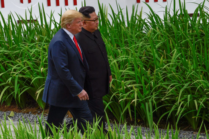 U.S. President Donald Trump and North Korean leader Kim Jong Un walk in the Capella Hotel after their working lunch, on Sentosa island in Singapore