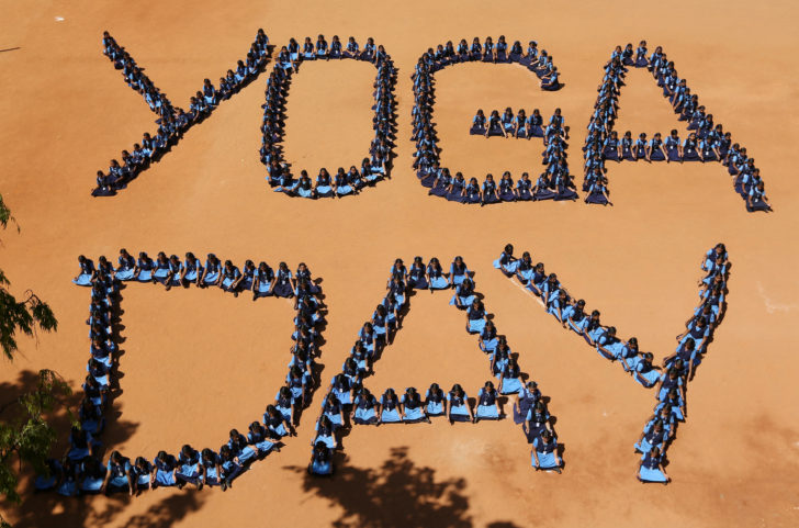 School children sit as they form the word