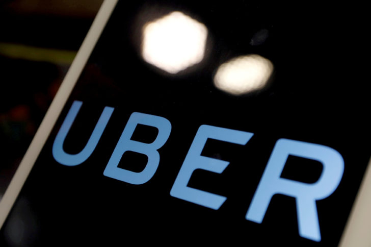 FILE PHOTO: The logo of Uber is seen on an iPad, during a news conference to announce Uber resumes ride-hailing service, in Taipei
