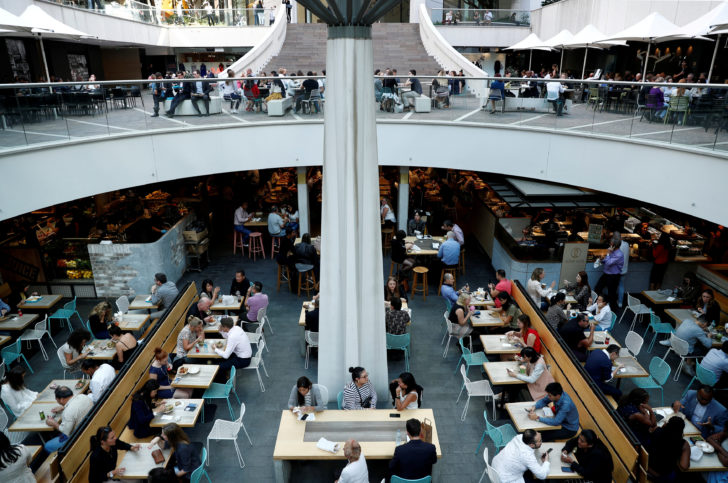 FILE PHOTO: Office workers take their lunch at a food court in Sydney