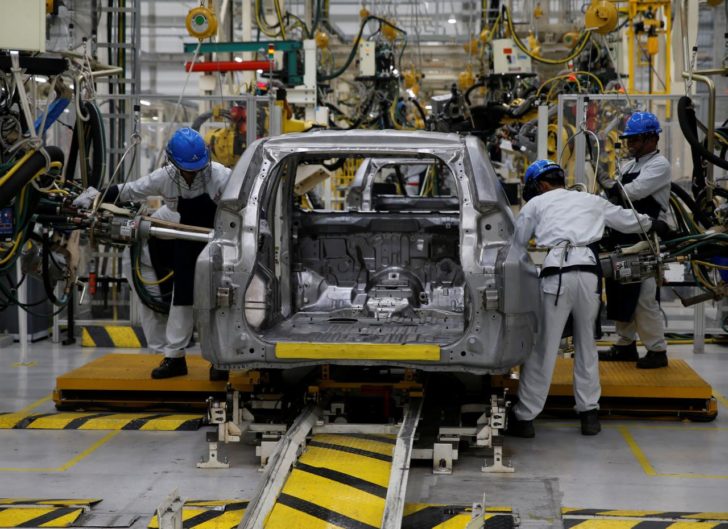 Workers are seen assembling a Mitsubishi Pajero at the Mitsubishi car factory in Bekasi