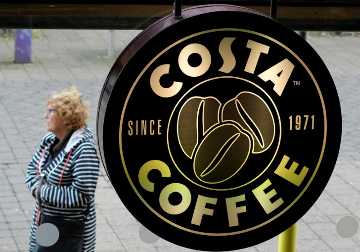 FILE PHOTO: A woman walks past a Costa Coffee in Loughborough