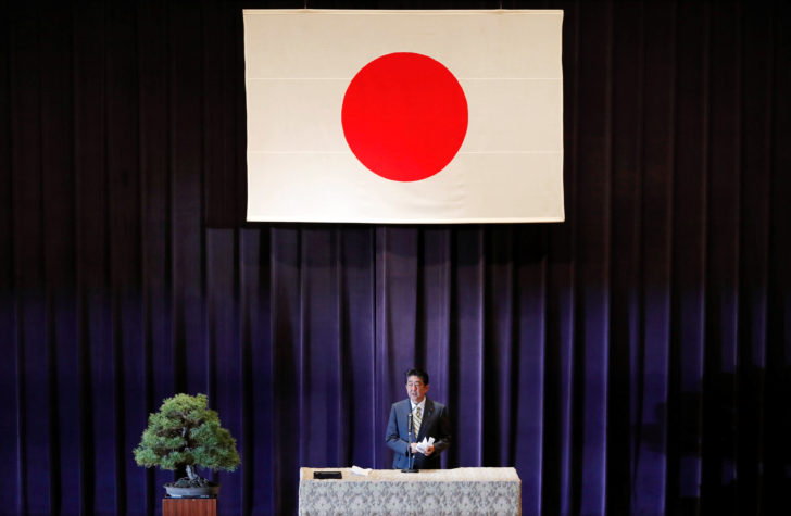 Japan's PM Abe addresses Japan's Self-Defense Forces senior members during a meeting at the Defense Ministry in Tokyo