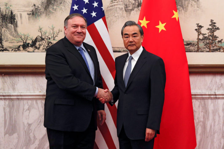 U.S. Secretary of State Mike Pompeo shakes hands with Chinese Foreign Minister Wang Yi as they pose for a photograph at the Diaoyutai State Guesthouse in Beijing