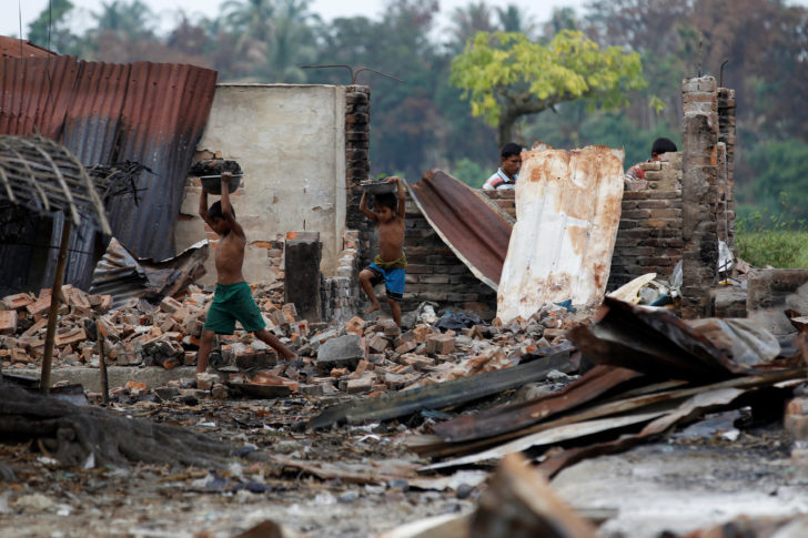 Children recycle goods from the ruins of a market which was set on fire at a Rohingya village outside Maugndaw in Rakhine state