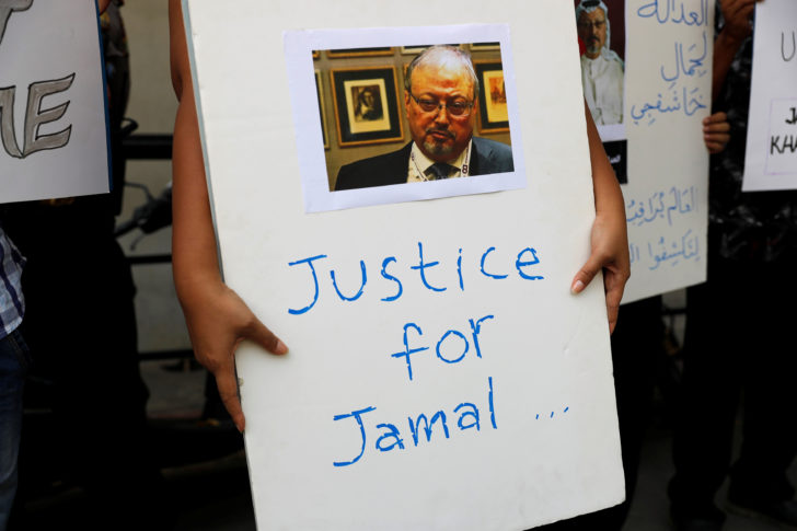 An Indonesian journalist holds a placard during a protest over the killing of Saudi journalist Jamal Khashoggi in front of the Saudi Arabia embassy in Jakarta