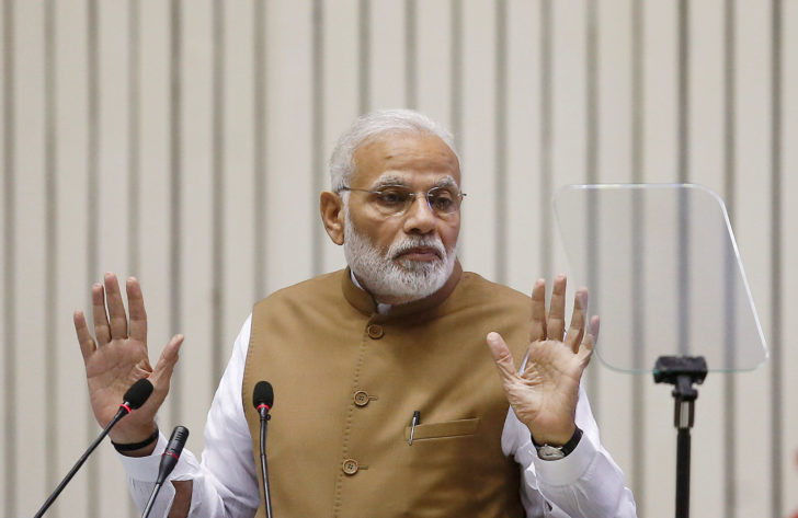 FILE PHOTO: India's Prime Minister Narendra Modi gestures as he addresses the gathering during the 'Global Mobility Summit' in New Delhi