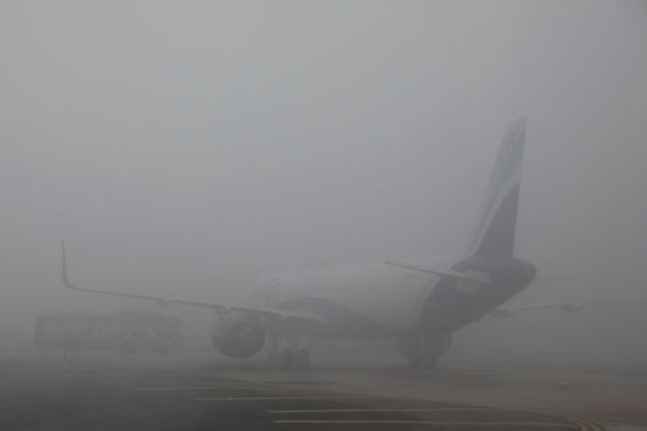 An IndiGo Airlines aircraft is seen shrouded in fog at Indira Gandhi International Airport in New Delhi