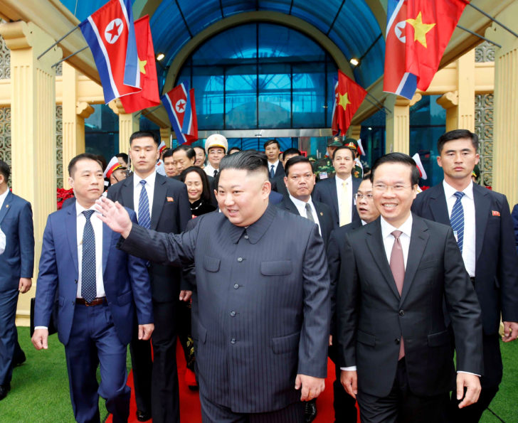 North Korea's leader Kim Jong Un waves upon his arrival at the border town with China in Dong Dang