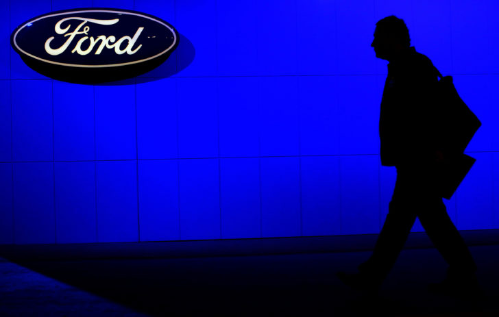 FILE PHOTO: A man walks past a Ford sign at the 2009 New York International Auto Show in New York
