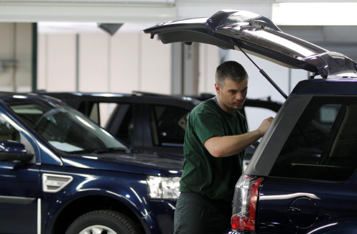 FILE PHOTO: Workers examine Land Rover Freelander vehicles as they come off the production line at Jaguar Land Rover's Halewood assembly plant in Liverpool