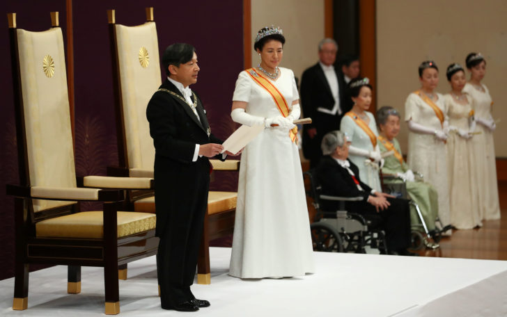 Japan's Emperor Naruhito, flanked by Empress Masako, delivers a speech during a ceremony called Sokui-go-Choken-no-gi, his first audience after the accession to the throne , at the Imperial Palace in Tokyo