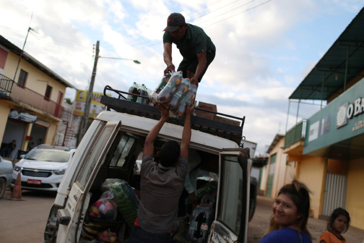 Venezuelans carry supplies inside a vehicle at the border city of Pacaraima