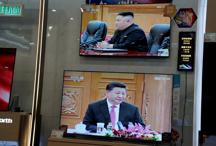 FILE PHOTO: Television screens show Chinese state media CCTV's footage of North Korean leader Kim Jong Un's meeting with Chinese President Xi Jinping, at an electronics store in Beijing
