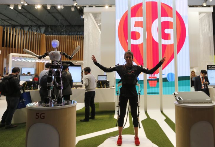 SK telecom exhibitor directs the robot's movements using 5G on the last day at the Mobile World Congress in Barcelona
