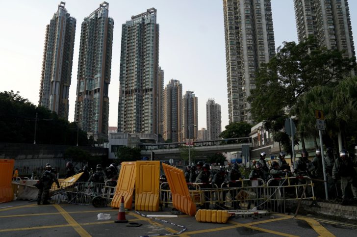 Riot police officers remove a barricade in Tuen Mun, Hong Kong