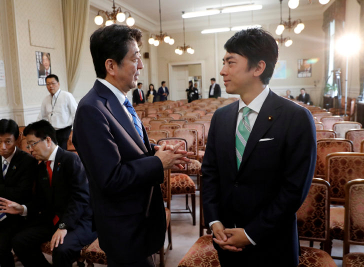 FILE PHOTO: Japan's Prime Minister Shinzo Abe talks with his party's lawmaker Shinjiro Koizumi at the party lawmakers' meeting after the dissolution of the lower house was announced at the Parliament in Tokyo ญี่ปุ่นปรับ ครม.ใหม่ ปูทางเพิ่มตัวเลือก “ผู้นำรุ่นใหม่” ในเลือกตั้ง 2021