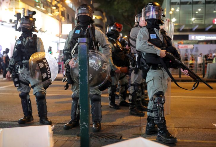 Riot police officers patrol after the