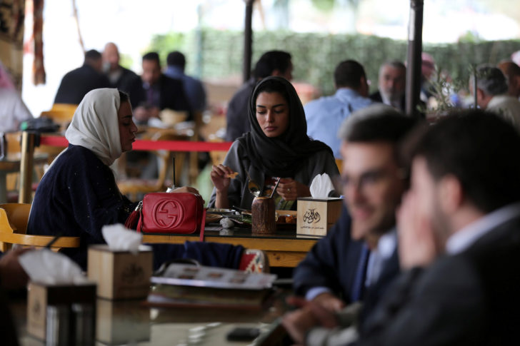 Saudi men and women sit at cafe in Riyadh