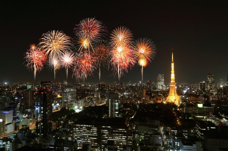 Fireworks celebrating over Tokyo cityscape at night