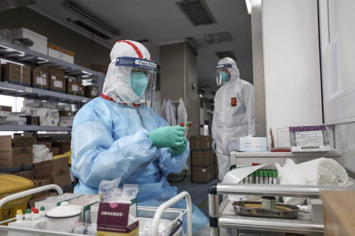 Medical worker in protective suit prepares for an RNA test at Jinyintan hospital in Wuhan, the epicentre of the novel coronavirus outbreak