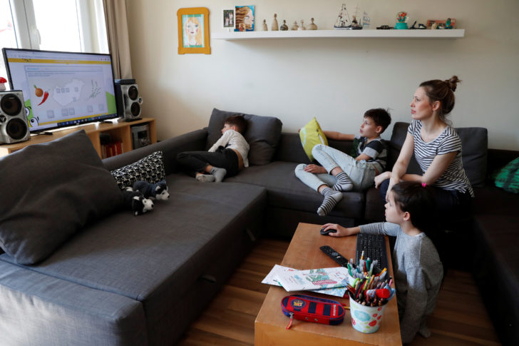 Agnes Nemes, a paper restorer working from home, studies with her children during the spread of coronavirus disease (COVID-19) in Budapest