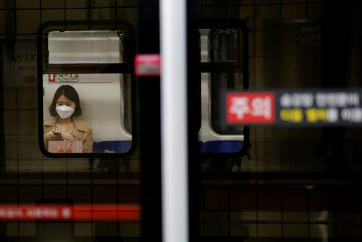 Woman wearing a face mask rides the subway amid the rise in confirmed cases of coronavirus disease (COVID-19) in Daegu