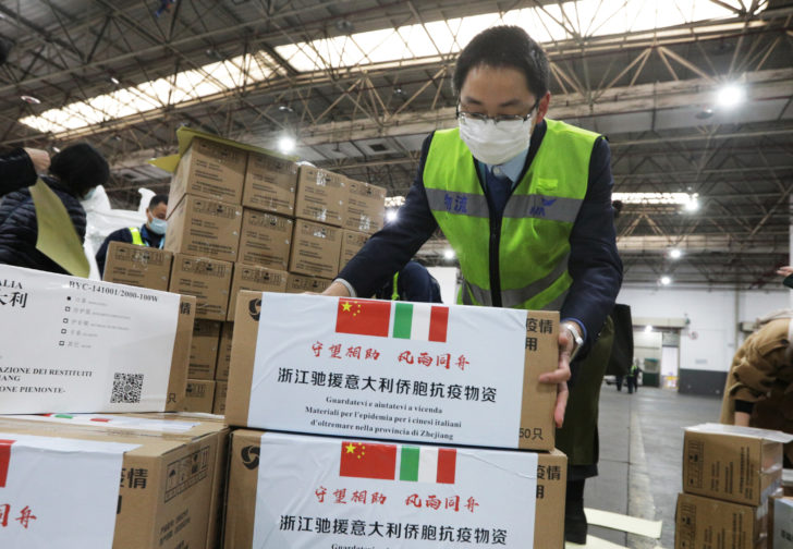 Staff members move medical supplies to be sent to Italy for the prevention of the novel coronavirus, following the coronavirus outbreak, at a logistics center of the international airport in Hangzhou, Zhejiang