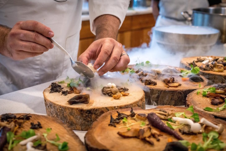chef-preparing-vegetable-dish-on-tree-slab-1267320