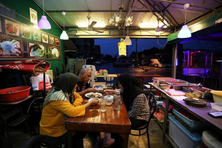Muslim family break their fast at the end of the day during the holy month of Ramadan inside their restaurant, amid the coronavirus disease (COVID-19) outbreak, in Selayang