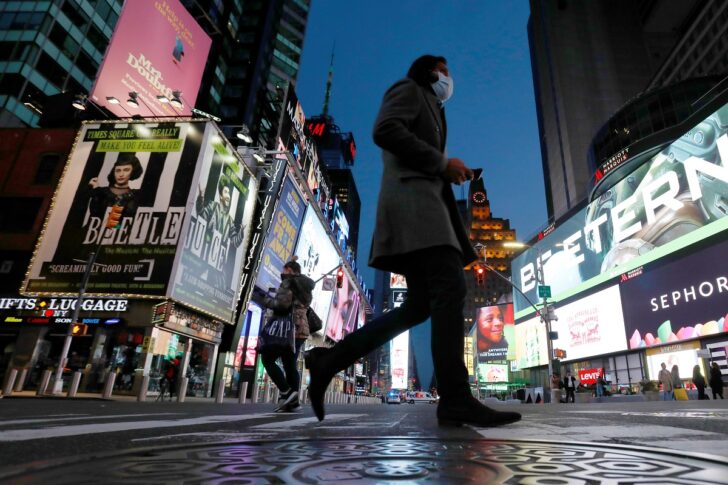 People walk in Times Square as the coronavirus disease (COVID-19) outbreak continues in Manhattan, New York City