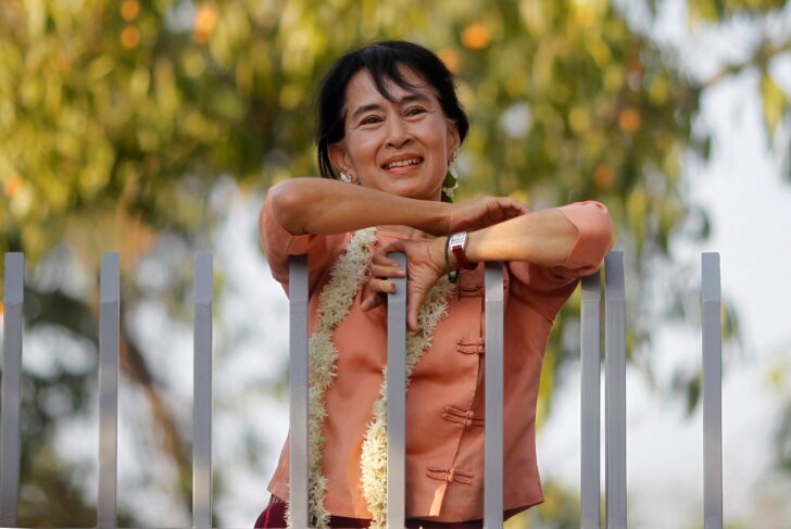 FILE PHOTO: Myanmar's pro-democracy leader Suu Kyi smiles at supporters as she celebrates Thingyan in front of her home in Yangon