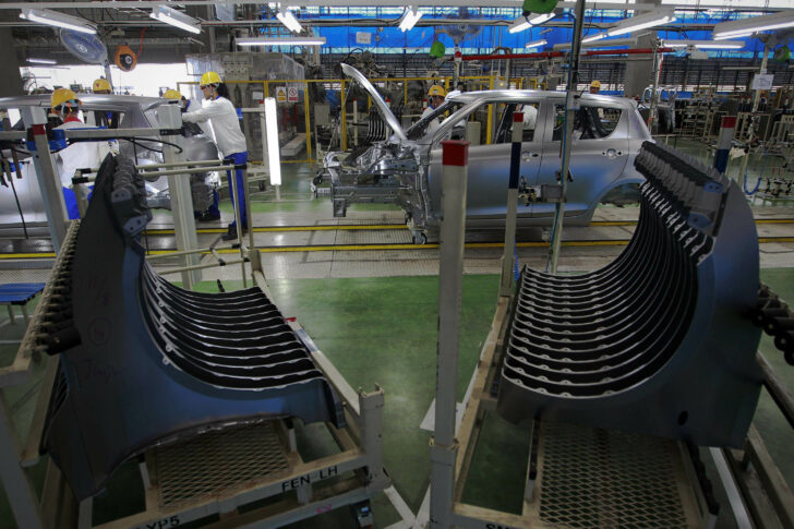 Employees work at a Suzuki Motor Corp plant, outside Bangkok