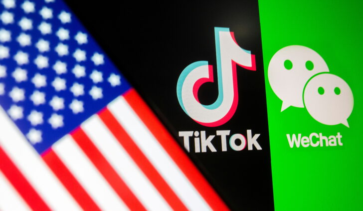 FILE PHOTO: U.S. flag is seen on a smartphone in front of displayed Tik Tok and WeChat logos in this illustration
