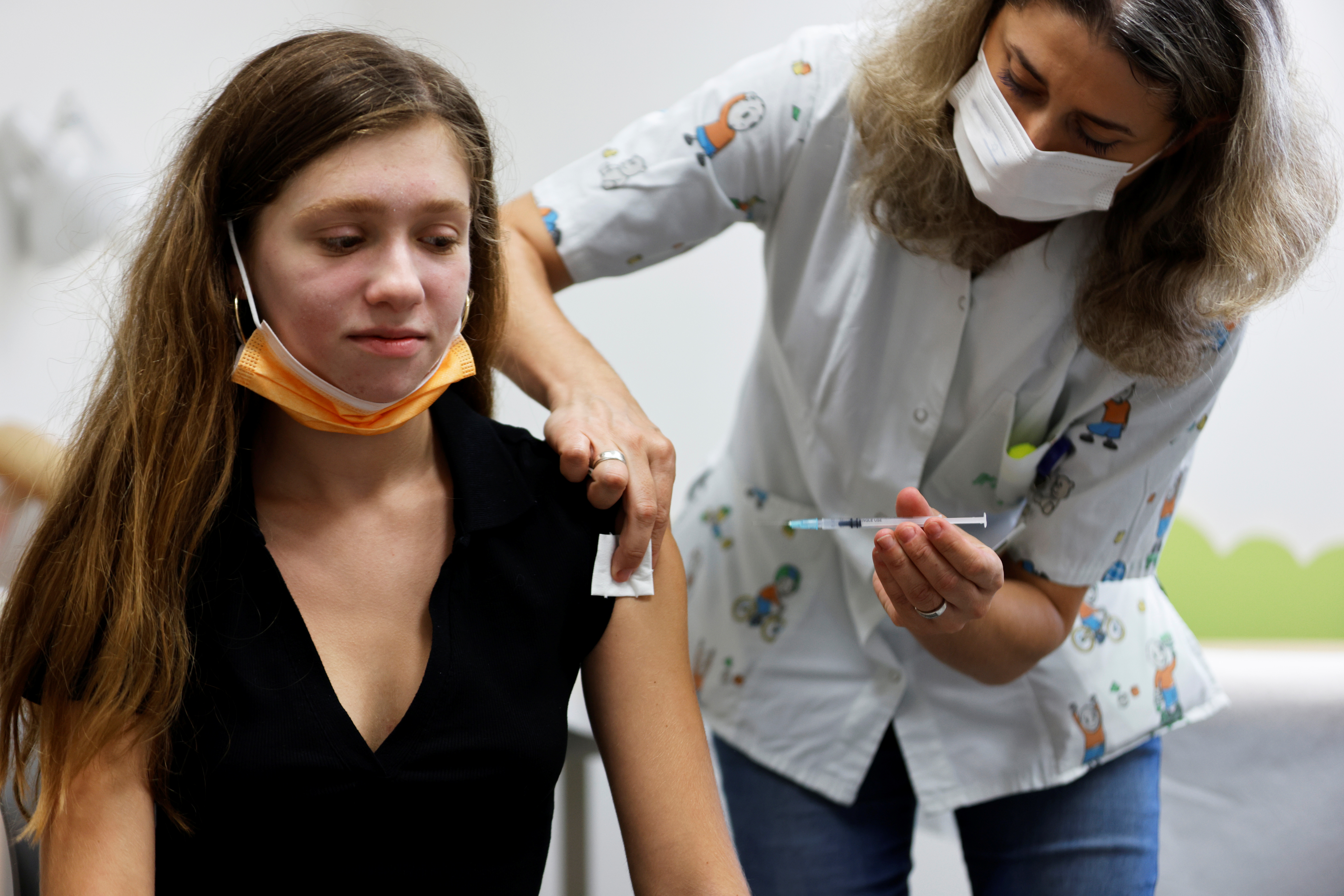 A teenager receives a dose of a vaccine against the coronavirus disease (COVID-19) in Tel Aviv